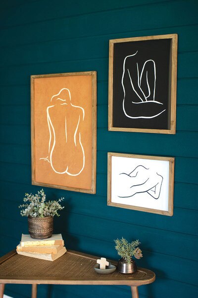 set of three framed nude prints under glass