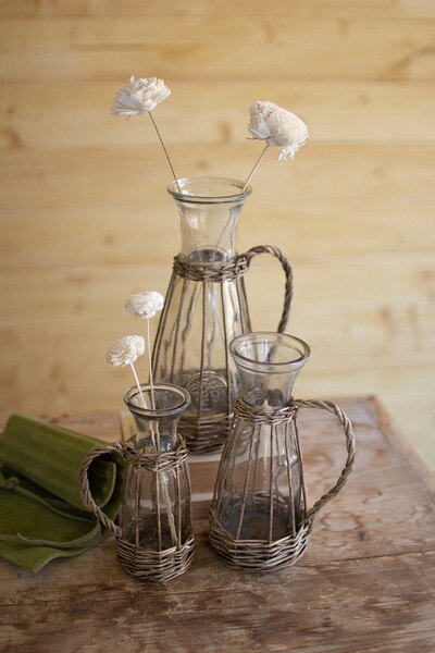 set of three wicker wrapped glass vases with handles