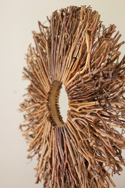 tabletop round twig sculpture on a wooden base