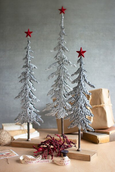 set of three metal christmas trees on wooden bases