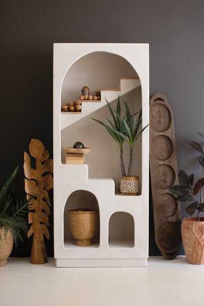 View of textured arched shelving unit with stairs detail