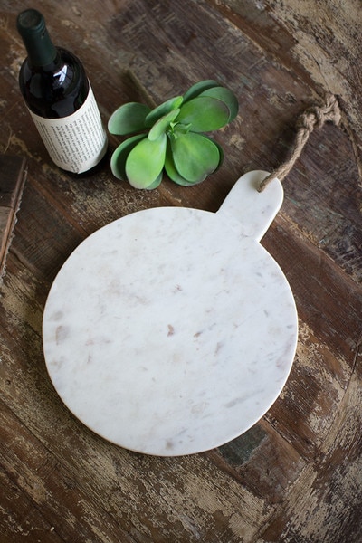 round white marble cutting board with jute hanger