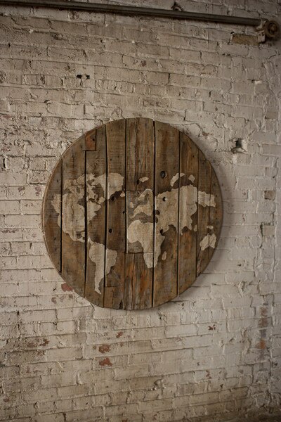 repurposed wooden spool world map