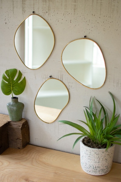 set of three brass framed organic shaped mirrors